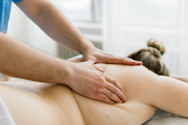 Young fat woman getting massage treatment in a day spa cabinet. - Foto, Bild