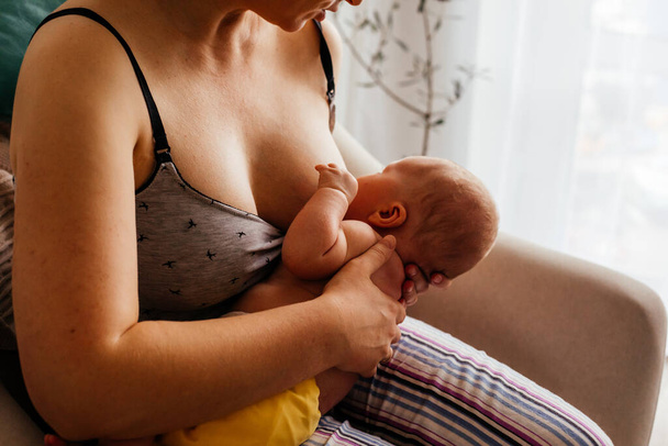 The young mom wants to breastfeed her newborn baby - Photo, Image