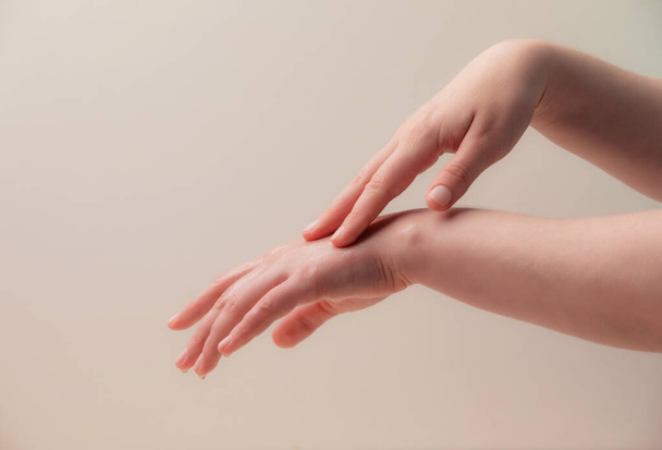 Female hands and nourishing oil on the beige - Zdjęcie, obraz