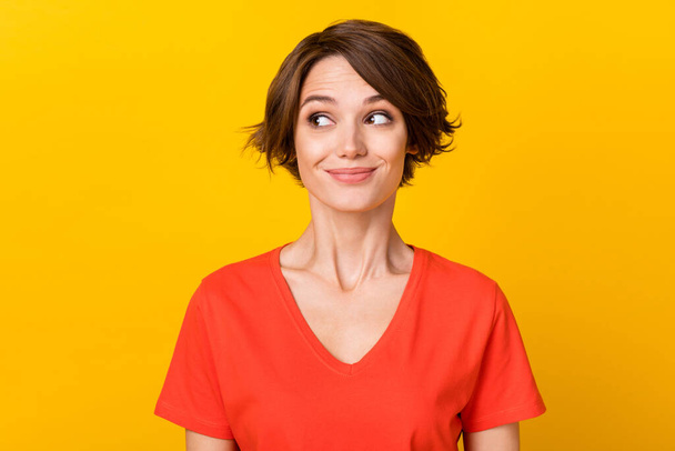 Photo of adorable friendly lady smile look interested empty space wear orange isolated on yellow color background - Fotografie, Obrázek