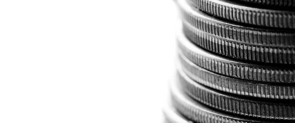 Closeup of stack of silver coins representing wealth and prosperity with white background for copyspace - Fotó, kép