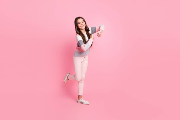 Full length photo of funny small girl dance good mood smile weekend isolated on pastel pink color background - Foto, Imagem