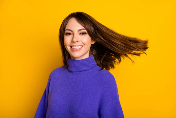 Photo of pretty charming young woman wear purple pullover air blowing hair isolated yellow color background - Fotografie, Obrázek