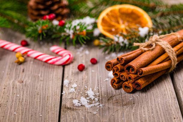 Christmas Holidays Composition Cinnamon and Christmas Decoration on Wooden Background. New Year Concept and Christmas banner. Selective focus. - Фото, изображение