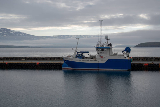 Boat in icy foggy Harbor in Dalvik Iceland - Photo, Image