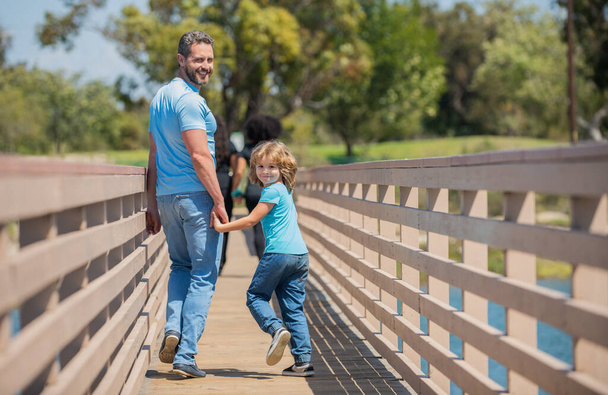 Mutlu bir baba oğluyla dışarıda dolaşırken, ebeveynlik yaparken. - Fotoğraf, Görsel