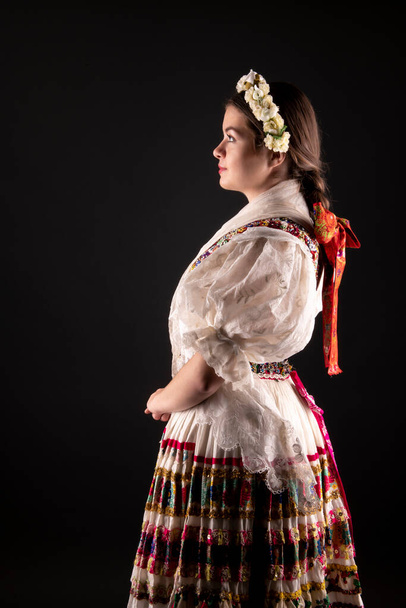 Young beautiful slovak woman in traditional dress. Slovak folklore - Фото, изображение