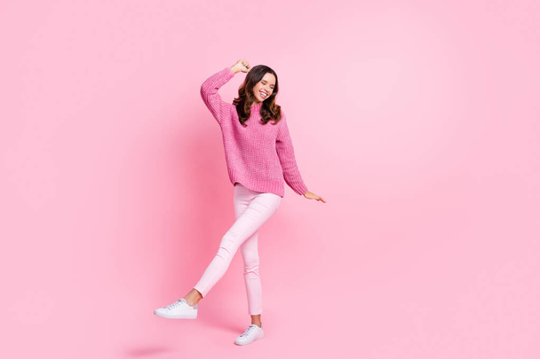 Full size photo of hooray cool brunette lady dance wear pink sweater trousers sneakers isolated on pink color background - Zdjęcie, obraz