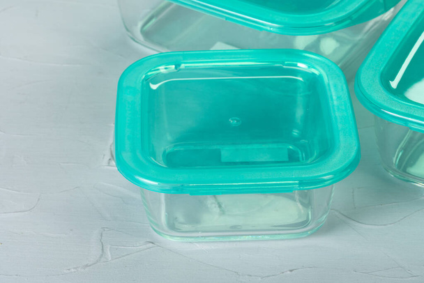 Set of plastic boxes kitchen ware on kitchen counter - Foto, afbeelding