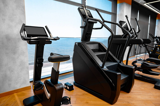 Modern gym interior with new fitness equipment - Foto, Bild