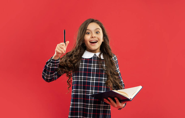 inspired with idea child making notes on red background, back to school - Zdjęcie, obraz