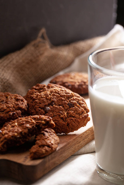 Chocolate crispy cookies with glass of milk close up - Φωτογραφία, εικόνα
