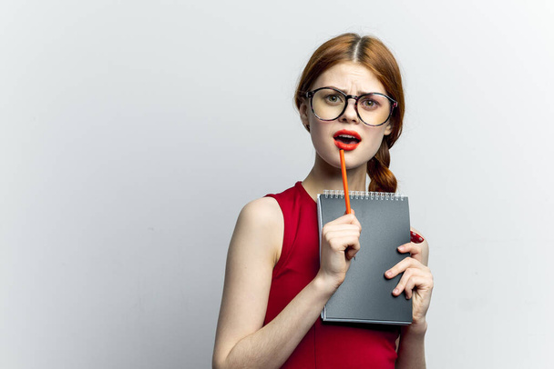cheerful woman with glasses red dress notepad work - Valokuva, kuva