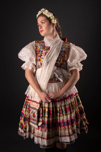 Young beautiful slovak woman in traditional dress. Slovak folklore - 写真・画像