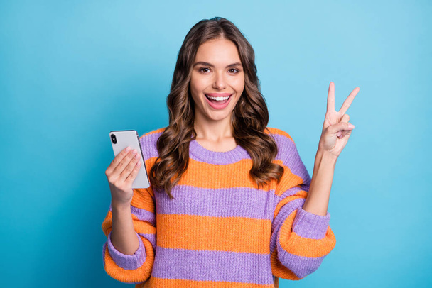 Photo of attractive nice pretty happy woman make v-sign hold phone isolated on paste blue color background - Φωτογραφία, εικόνα
