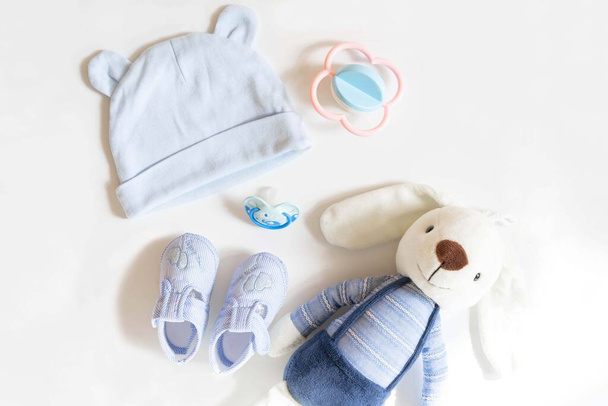 Newborn baby clothing and rabbit toy on white background,Top view, flat lay. - Photo, image