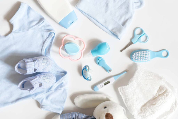 childhood and Childcare concept - Simple tools for baby, diaper, lotion, thermometer, aspirator nasal, Scissors,nail clippers, Medicine Dropper, baby nose cleaner,toy, pacifier - 写真・画像