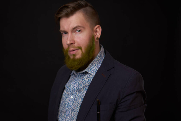fashionable business man in a jacket with a beard posing - Photo, image