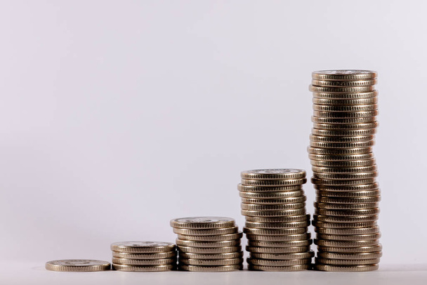 Stacks of coins in a growing progression. Background with copy space for text or inscriptions. Business economic development concept - Foto, Imagem