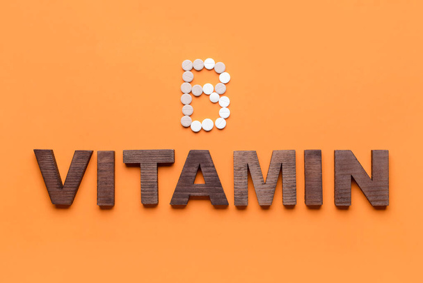 Word VITAMIN and letter B made of pills on color background - Foto, imagen
