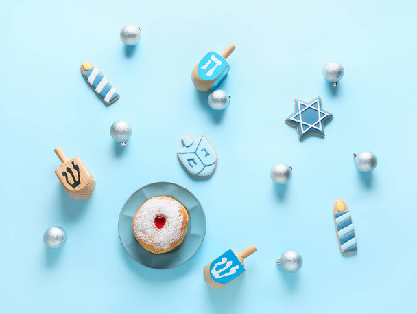 Symbols of Hanukkah with Christmas decor on color background - 写真・画像