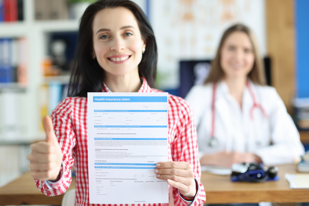 Woman shows document about health insurance, close-up. - Fotoğraf, Görsel