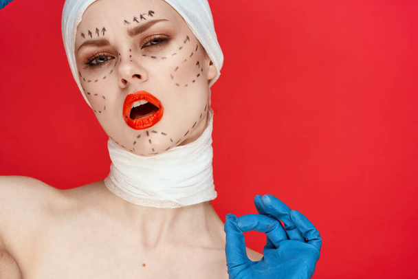 beautiful woman posing in blue gloves red lips surgery facial rejuvenation studio lifestyle - Photo, image