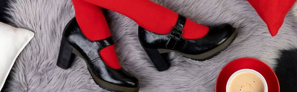 Womens legs in fashionable shoes on gray furry background - Zdjęcie, obraz