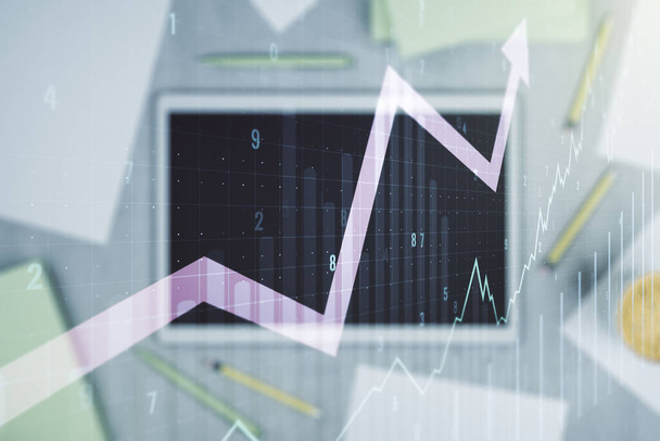 Double exposure of abstract creative financial chart with upward arrow and digital tablet on background, top view, research and strategy concept - 写真・画像