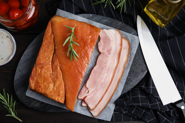 Flat lay composition with delicious smoked bacon on wooden table - Φωτογραφία, εικόνα