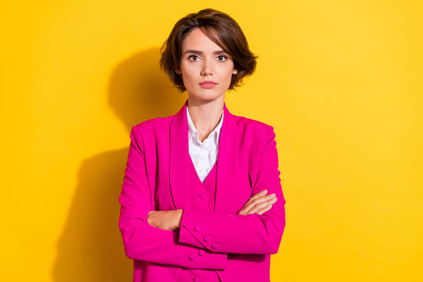 Portrait of attractive serious businesswoman economist wearing vest folded arms isolated over bright yellow color background - Foto, Bild