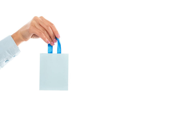 cropped view of woman holding tiny paper bag isolated on white  - Фото, зображення