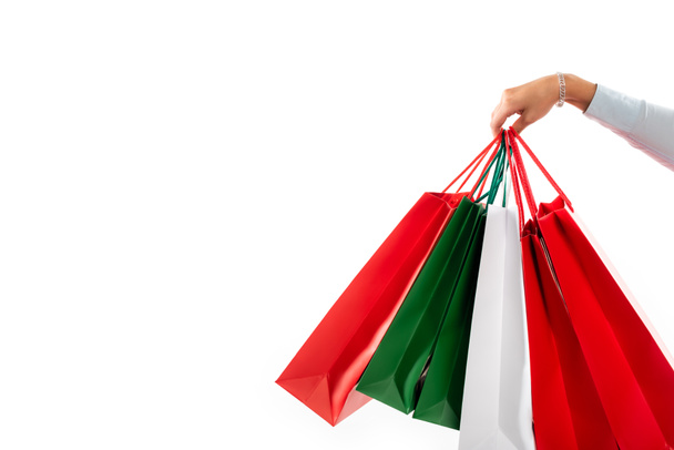 cropped view of female hand holding shopping bags isolated on white - Foto, imagen