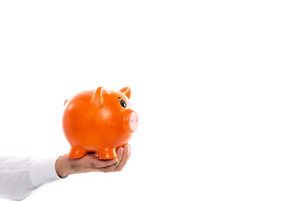 cropped view of man holding orange piggy bank isolated on white - Fotografie, Obrázek