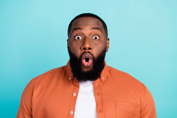 Photo of young black man amazed shocked omg fake novelty news isolated over turquoise color background - 写真・画像