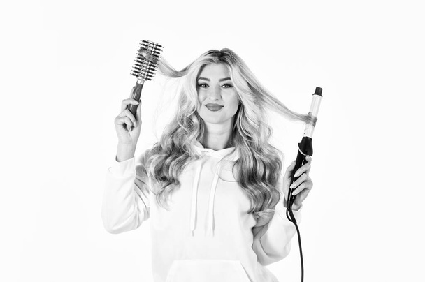 Using different wrapping techniques. Choose right type curling iron for your needs. Create hairstyle. Woman with long curly hair use curling iron. Hairdresser tips. Girl adorable blonde. Online shop - 写真・画像
