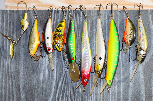 Fishing lures and equipment, wobblers on the table - Fotó, kép