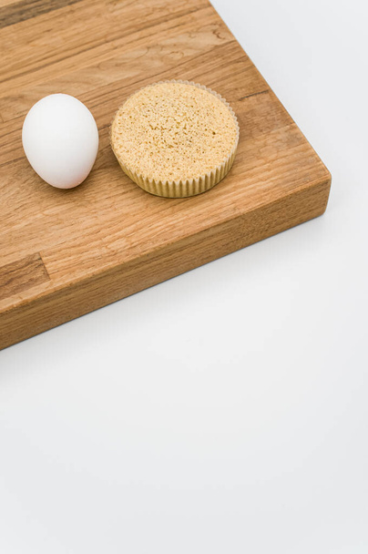 buckwheat flour and almonds organic cake and one egg on a wooden and white background with copy space - Φωτογραφία, εικόνα