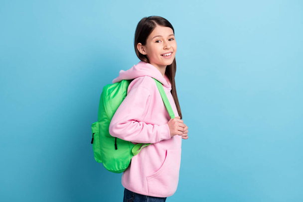 Profile side photo of young preteen girl happy positive smile pupil wear backpack isolated over blue color background - Zdjęcie, obraz