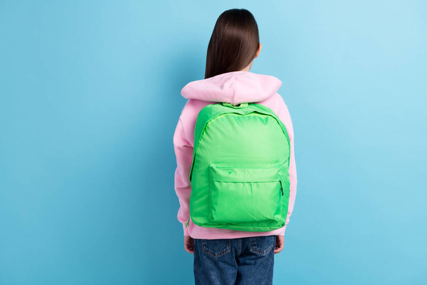 Photo of sporty cute school girl back wear pink sweatshirt schoolbag empty space isolated blue color background - Photo, Image