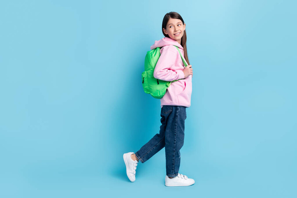 Full length body size profile side view of attractive cheerful girl going to classes isolated over bright blue color background - Photo, image