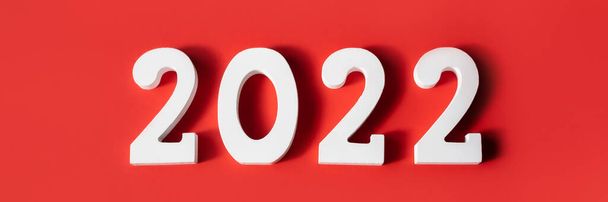 Happy New Year. White wooden numbers 2022 isolated on red background . Greeting card. Banner. Top view, flat lay. - Foto, Bild