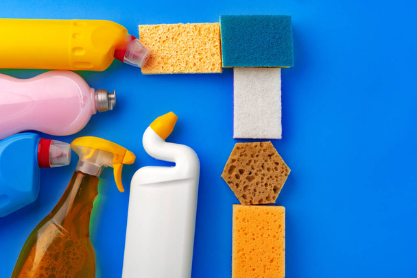 House cleaning supplies on blue color background - Fotó, kép