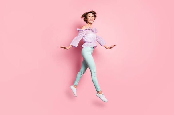 Full length photo portrait of charming girl walking jumping up isolated on pastel pink colored background - Foto, immagini