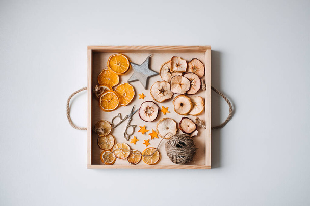 Eco friendly zero waste dried orange slices and DIY tools and stuff on the table. Handmade dried orange for Christmas decorations and Christmas presents. - Photo, image