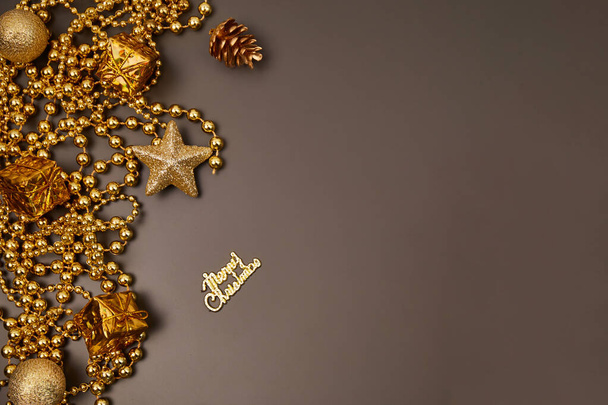 Christmas golden decorations with gift boxes on dark background. Template for greeting card. Copy space - Foto, immagini
