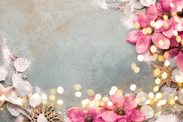 Beautiful Christmas pink flower on vintage blue background. Flat lay design. Copy Space. Horizontal. - Fotoğraf, Görsel