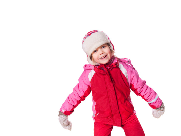 The laughing girl wearing red overalls and mittens with snow - Фото, изображение