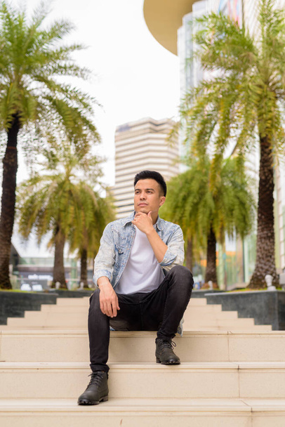 Portrait of handsome young stylish man outdoors in city - Photo, image