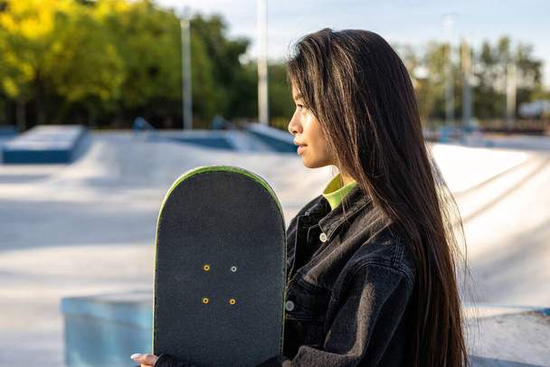 Stylish cool teen female skateboarder at skate park - Φωτογραφία, εικόνα